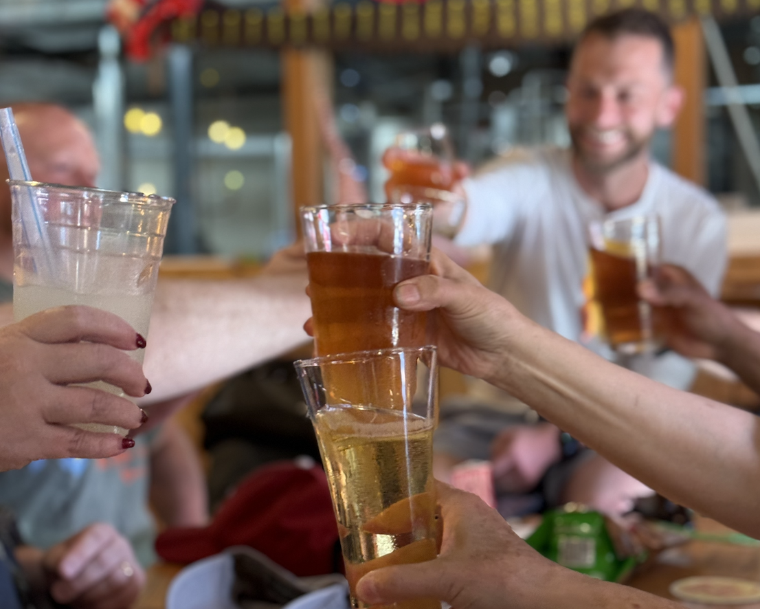 Group of friends raising beer glasses during a Poulsbo tasting tour