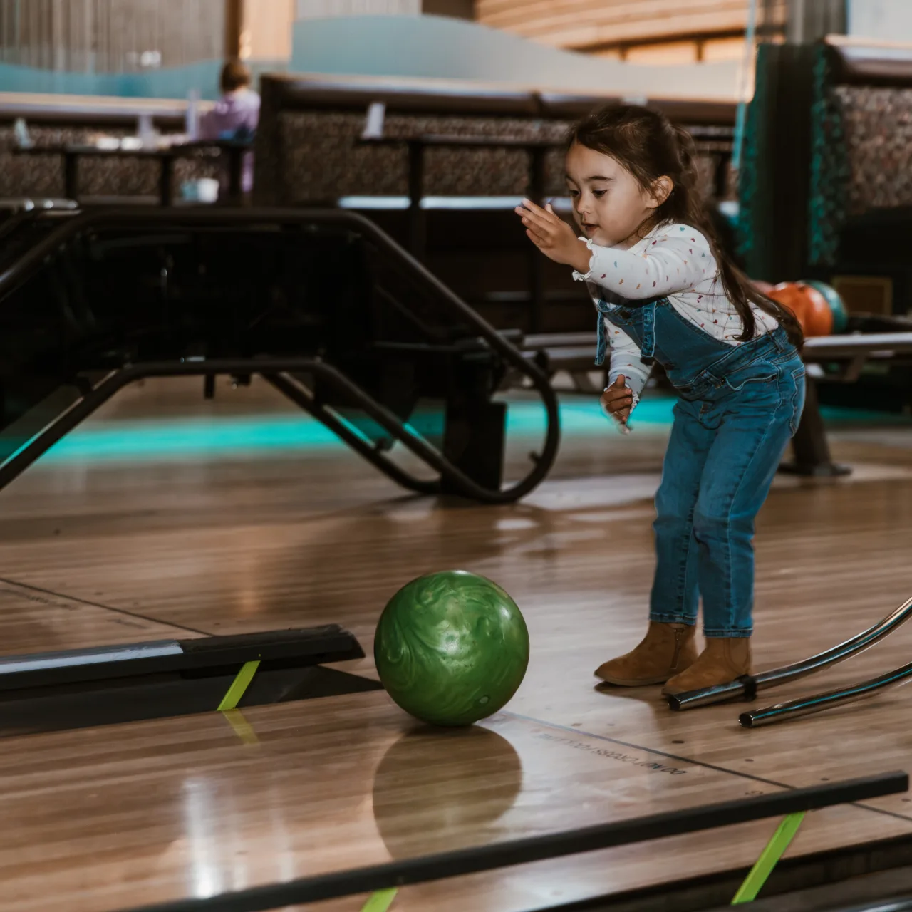 Child rolling a ball on Ocean5 duckpin bowling lanes
