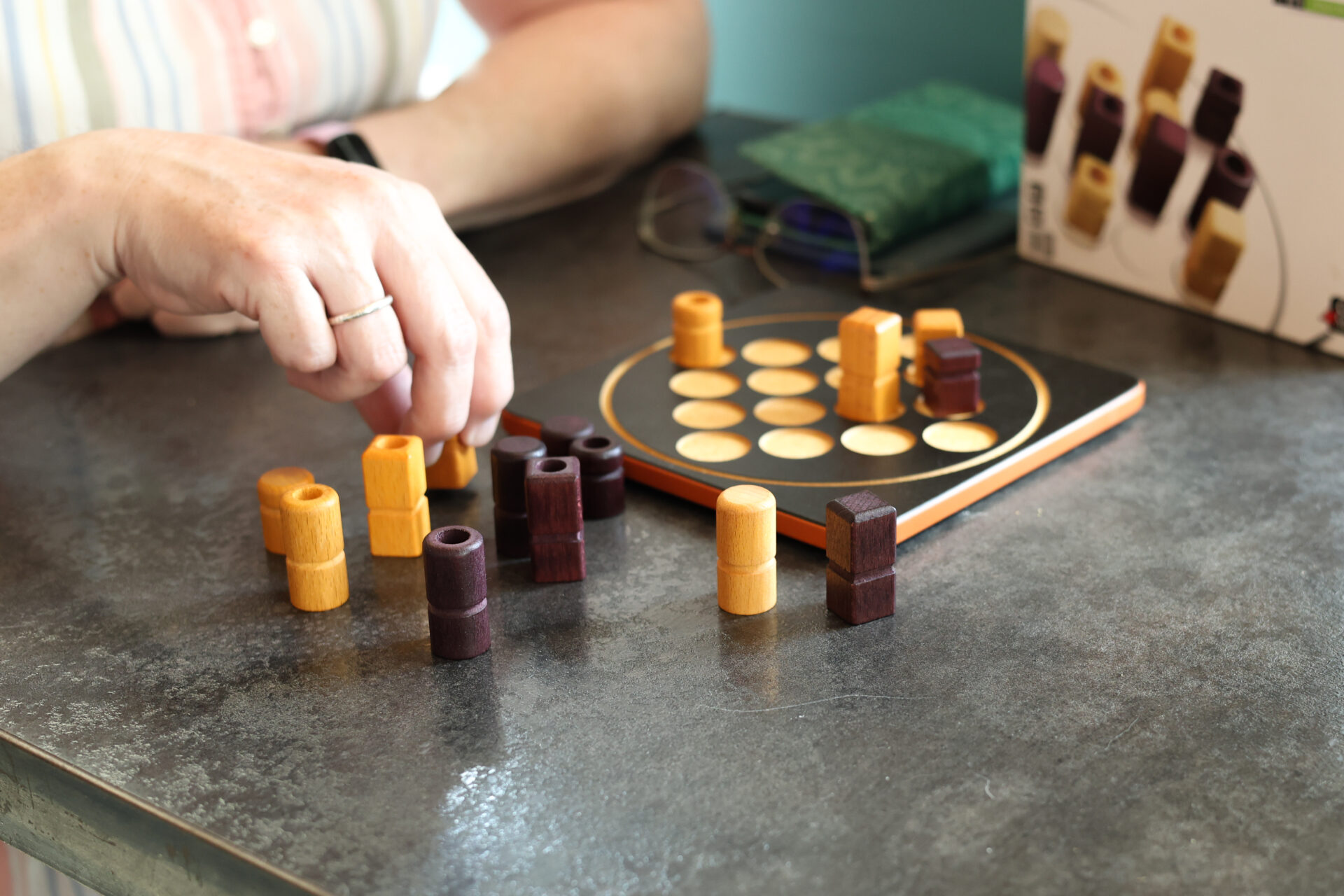 Guest playing a tabletop strategy game at The 15% Board Game Cafe