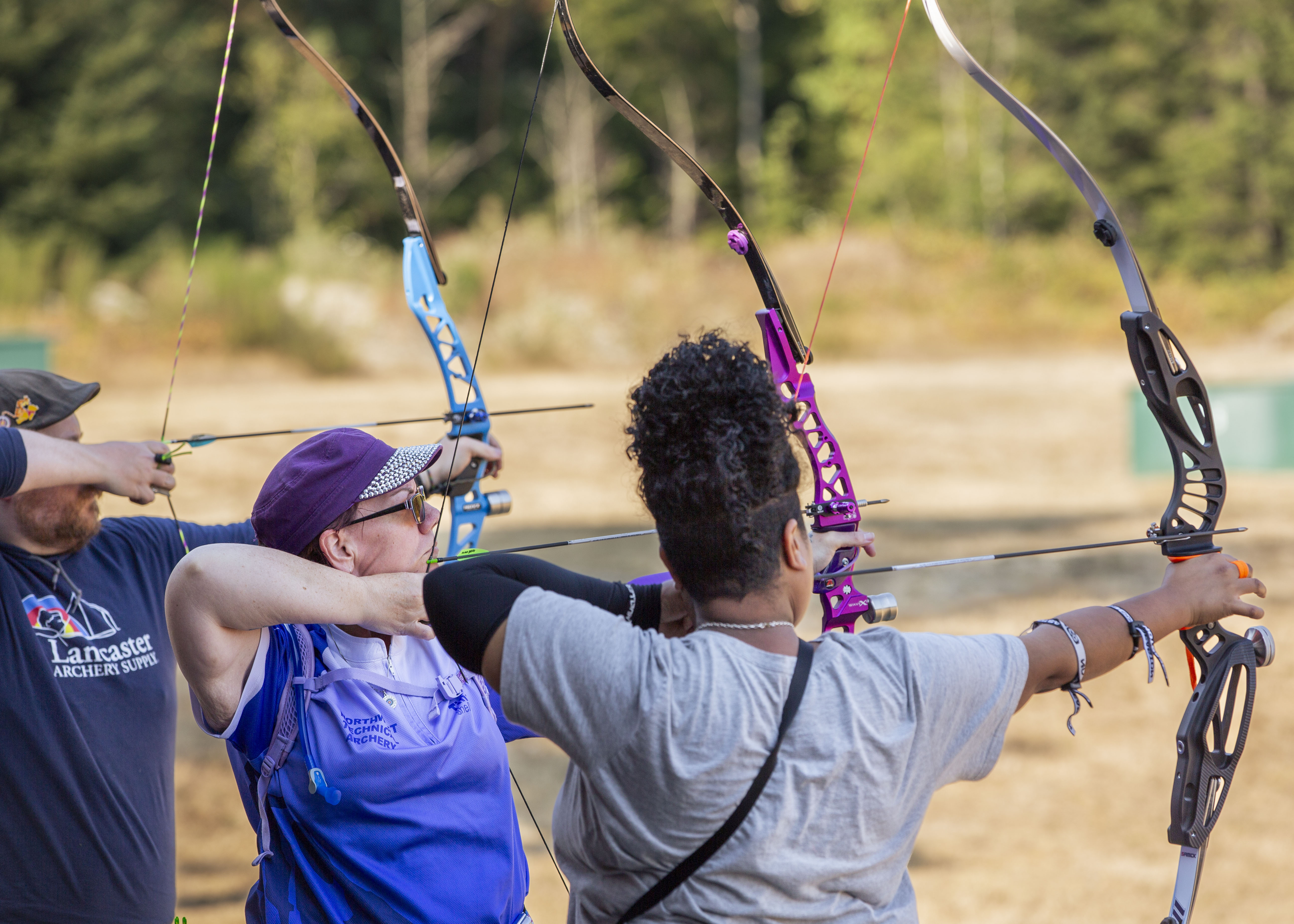 NW Technical Archery instructor coaching students with bows on the range