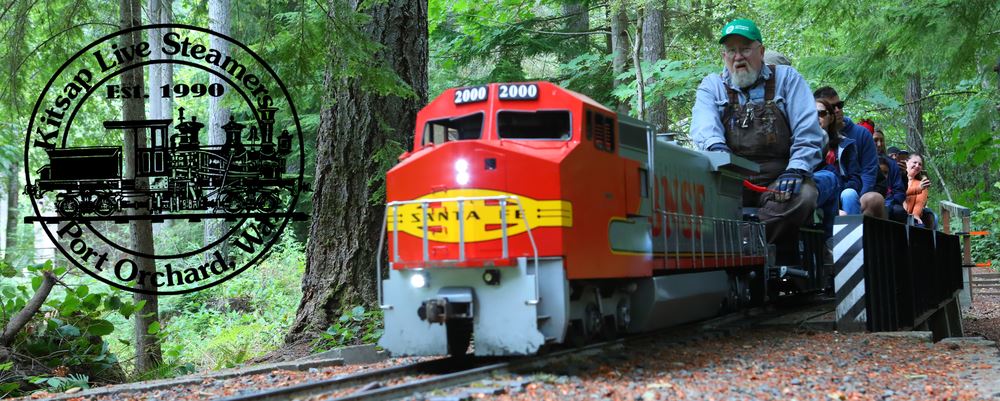 Kitsap Live Steamers miniature Santa Fe train carrying riders through the woods